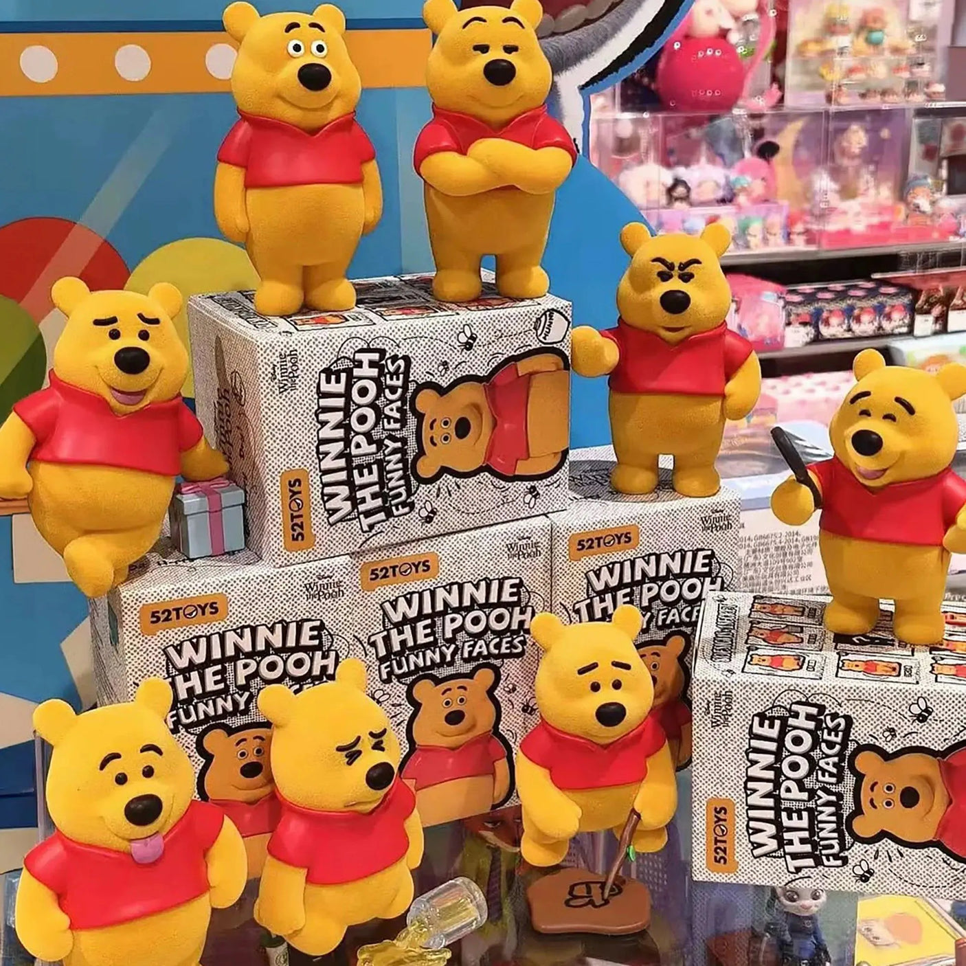 Assorted Winnie the Pooh blind box figures on display with “Funny Faces” packaging