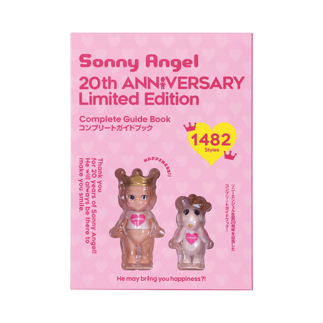 A pink box features the Sonny Angel 20th Anniversary - Complete Guide Book. Inside, two heart-themed figures are visible through a transparent front. Celebrate with this collector's item and its "1482 styles" to remember special moments. Brand: Sonny Angel.