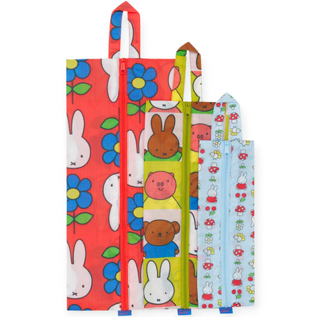 The Baggu Miffy x Baggu - Storage & Travel Set features three zippered pouches in red, green, and light blue with playful rabbit and flower prints—a cute, upright storage and travel solution for your essentials.