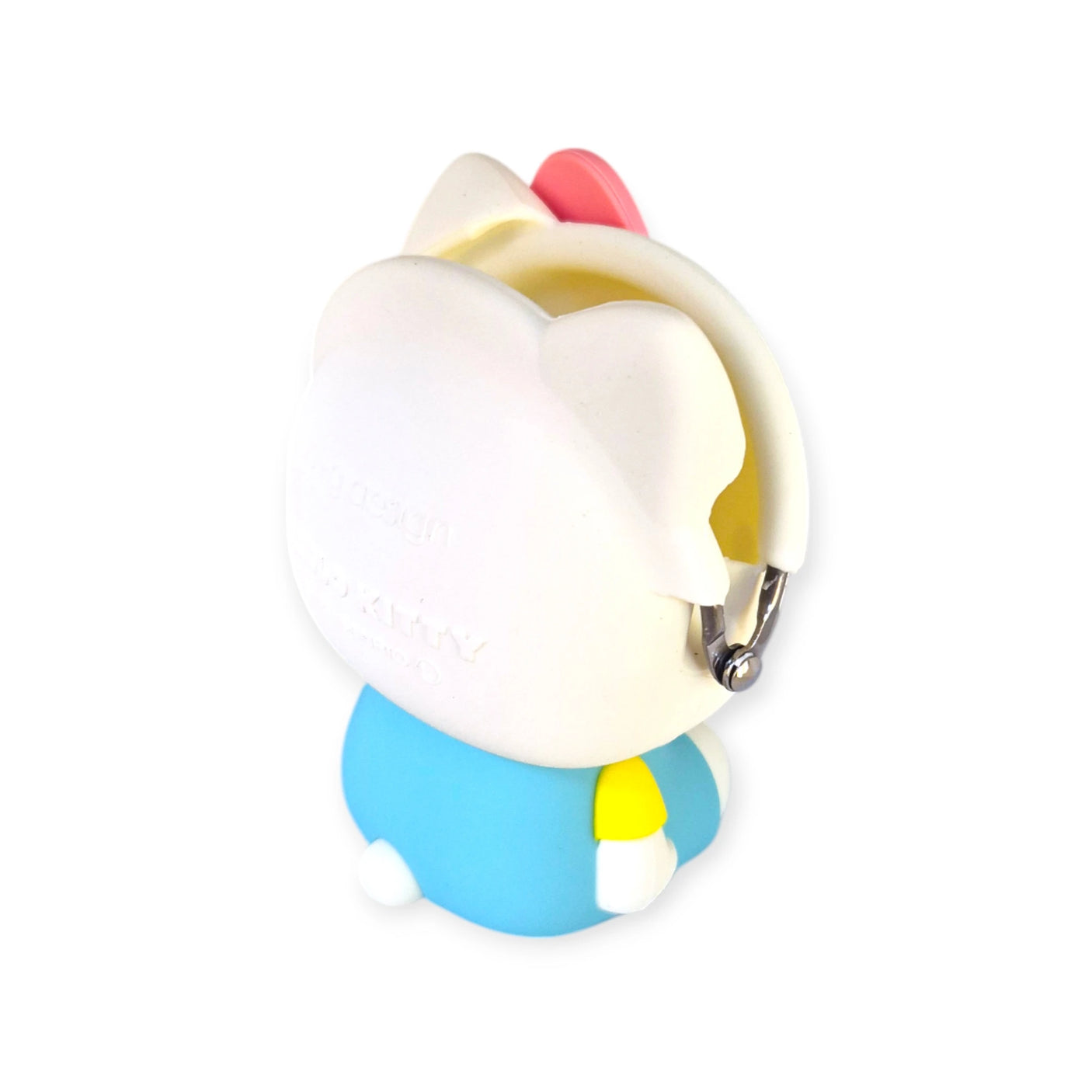 A small, cartoon-style cat figurine with white fur, a red bow, and a light blue outfit that resembles the 3D Hello Kitty Case by Hello Kitty is shown facing away.