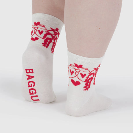 Cream bamboo crew socks featuring red cowgirl and heart designs, viewed from rear, gallery position 1