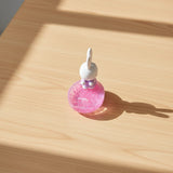 Pink pearl phone stand base with white bunny figurine, angled upright phone rest