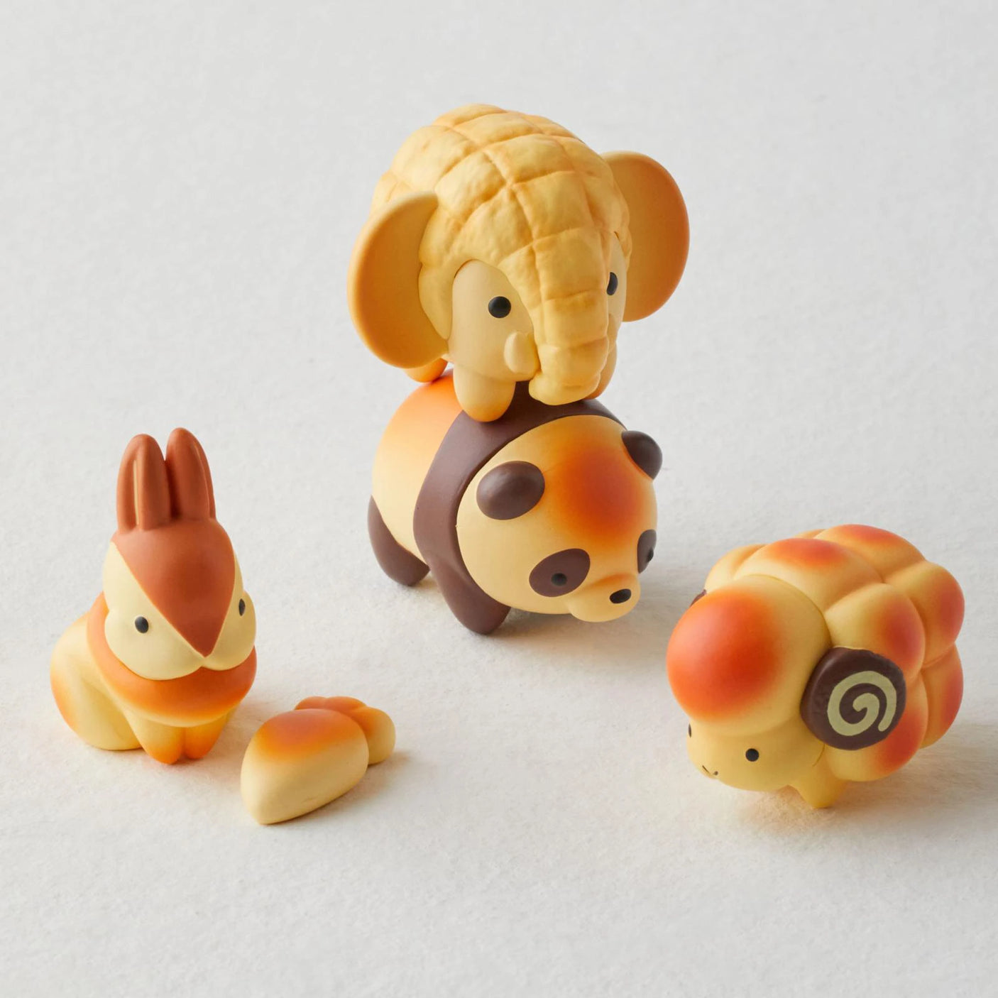 Explore the whimsical world of Dreams Inc's Animal Bakery Mini Figure Blind Box series, including four pastel-colored figures: an elephant on a panda, a rabbit, a carrot, and a sheep with ram's horns. Perfect for collectors!.