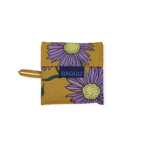 Folded Baby Baggu reusable bag with purple daisy floral print on mustard background, compact pouch, gallery position 1