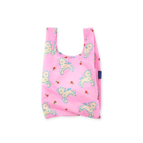 Pink reusable shopping bag with playful white lamb and small red flower pattern and fabric tag on side
