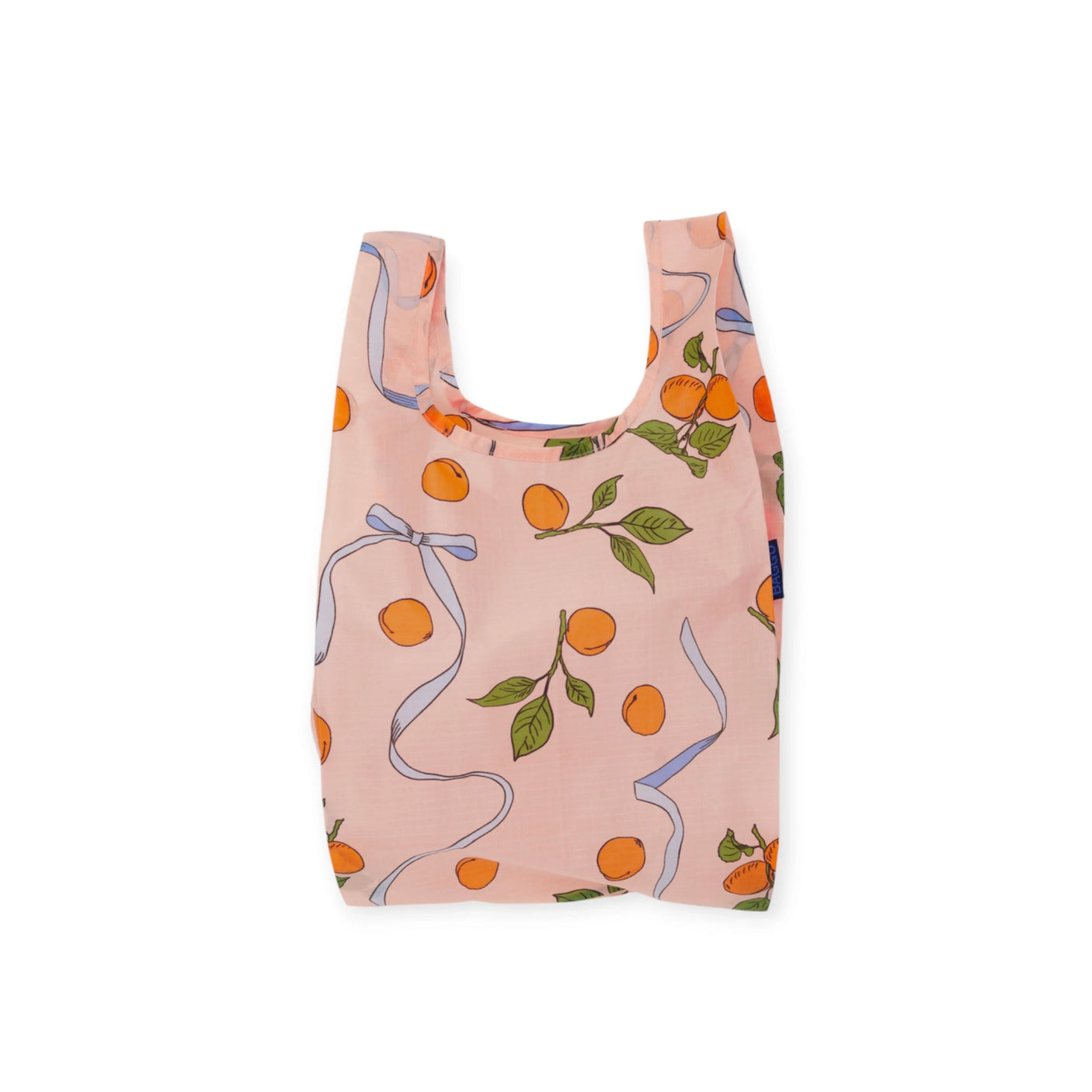 The Baby Baggu Reusable Bag by Baggu, made from 100% recycled nylon, showcases the Apricots & Ribbons design with orange fruits and green leaves on a pink background.