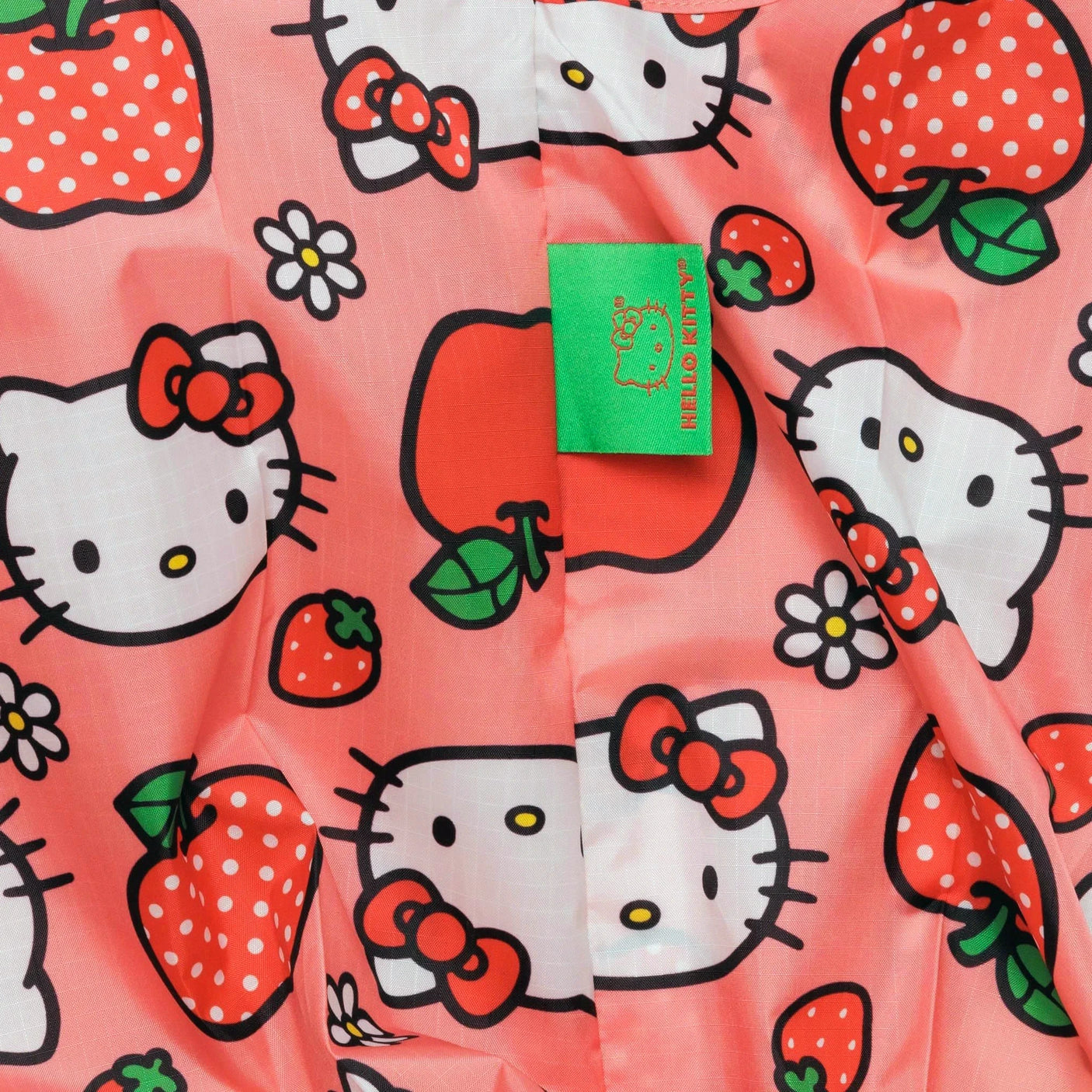 This limited-edition fabric in pink highlights Hello Kitty and strawberries, making it an ideal choice for the Baby Baggu Bag - Hello Kitty Apple by Baggu.