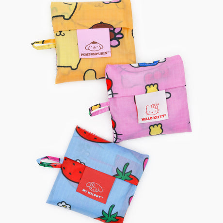 Three folded Baby Baggu x Hello Kitty reusable bags with PomPomPurin, Hello Kitty, and My Melody patches, white background
