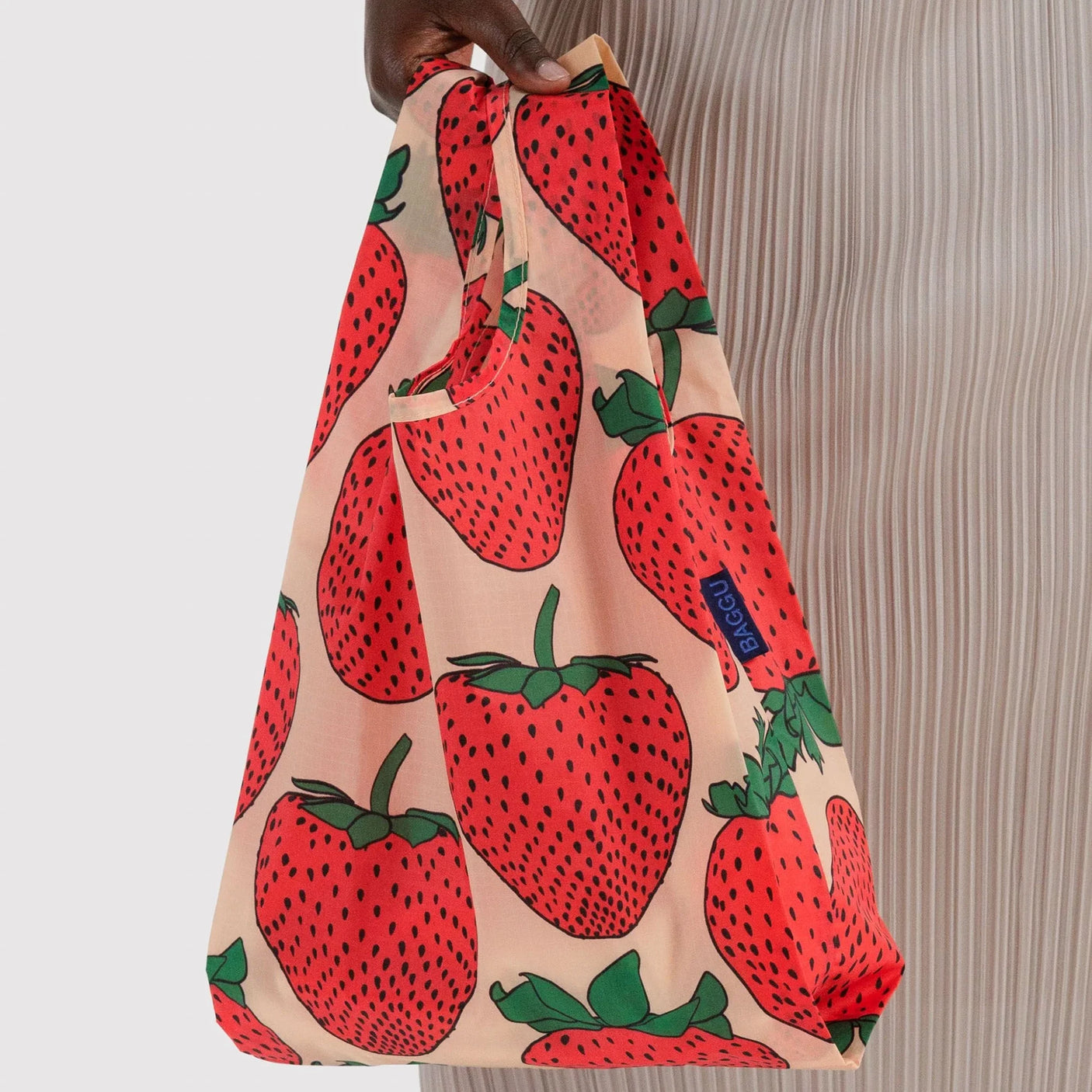 Baby Baggu bag with strawberry print, tote held by top handle