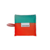 The Baby Baggu Bag x Julia Heuer - Rain by Baggu is a square fabric pouch adorned with a red and teal design, featuring a small handle and "Julia Heuer" label, crafted from recycled nylon.