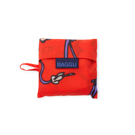 Compact folded Baby Baggu bag in vibrant red featuring a purple snapdragon design with blue Baggu label on white background