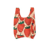 Introducing the Baggu Baby Baggu Reusable Bag - Strawberry, a charming tote bag adorned with a delightful strawberry pattern on a light background. Perfect for everyday errands or carrying essentials in style, this eco-friendly accessory combines functionality with whimsical flair.