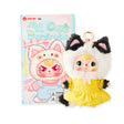 Baby Three - Kitten Wardrobe Keychain Blind Box featuring doll in yellow dress and black white cat costume with box.