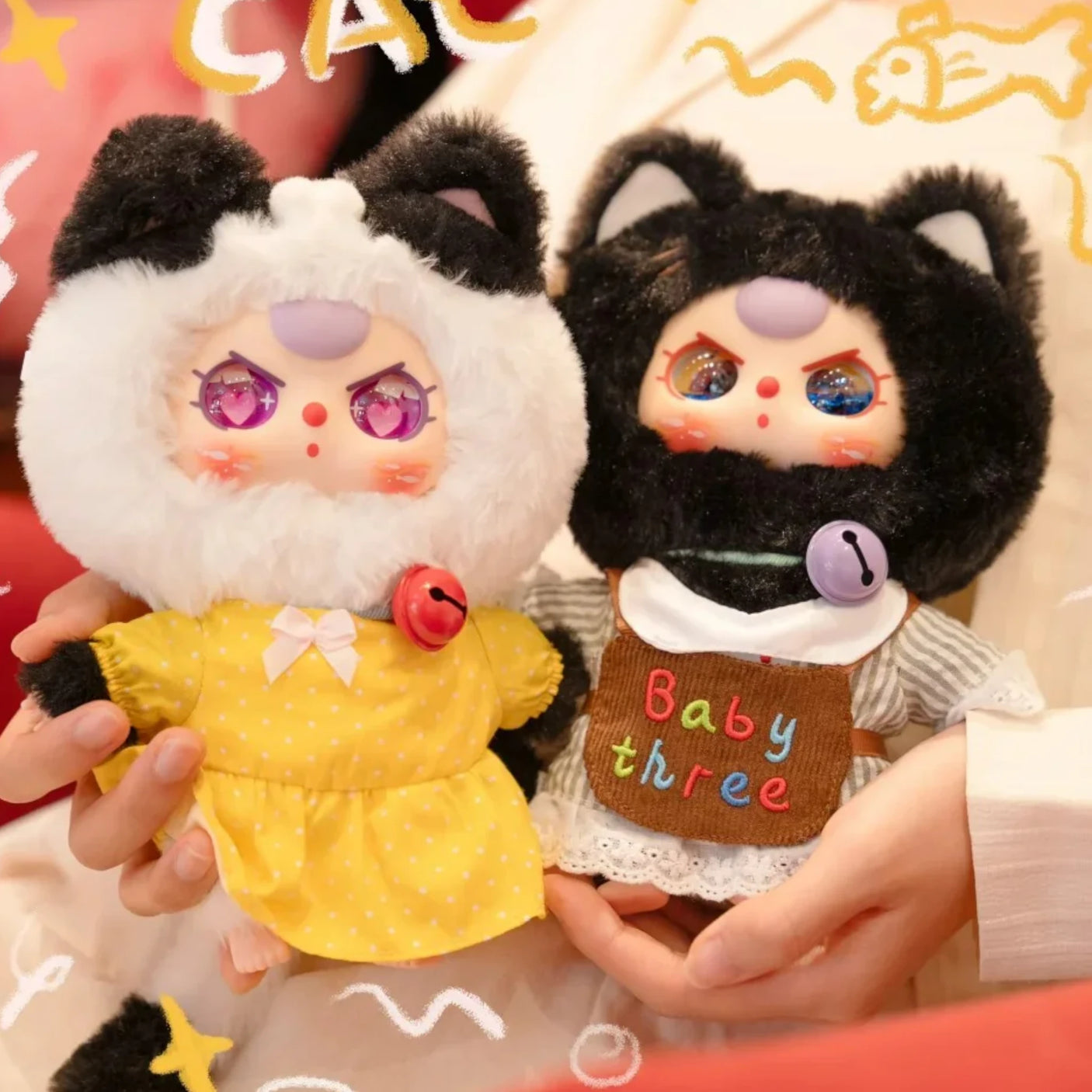 Baby Three - Kitten Wardrobe Keychain Blind Box dolls in black and white cat costumes with bell necklaces and colorful outfits held by hands