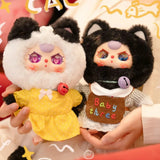 Baby Three - Kitten Wardrobe Keychain Blind Box dolls in black and white cat costumes with bell necklaces and colorful outfits held by hands