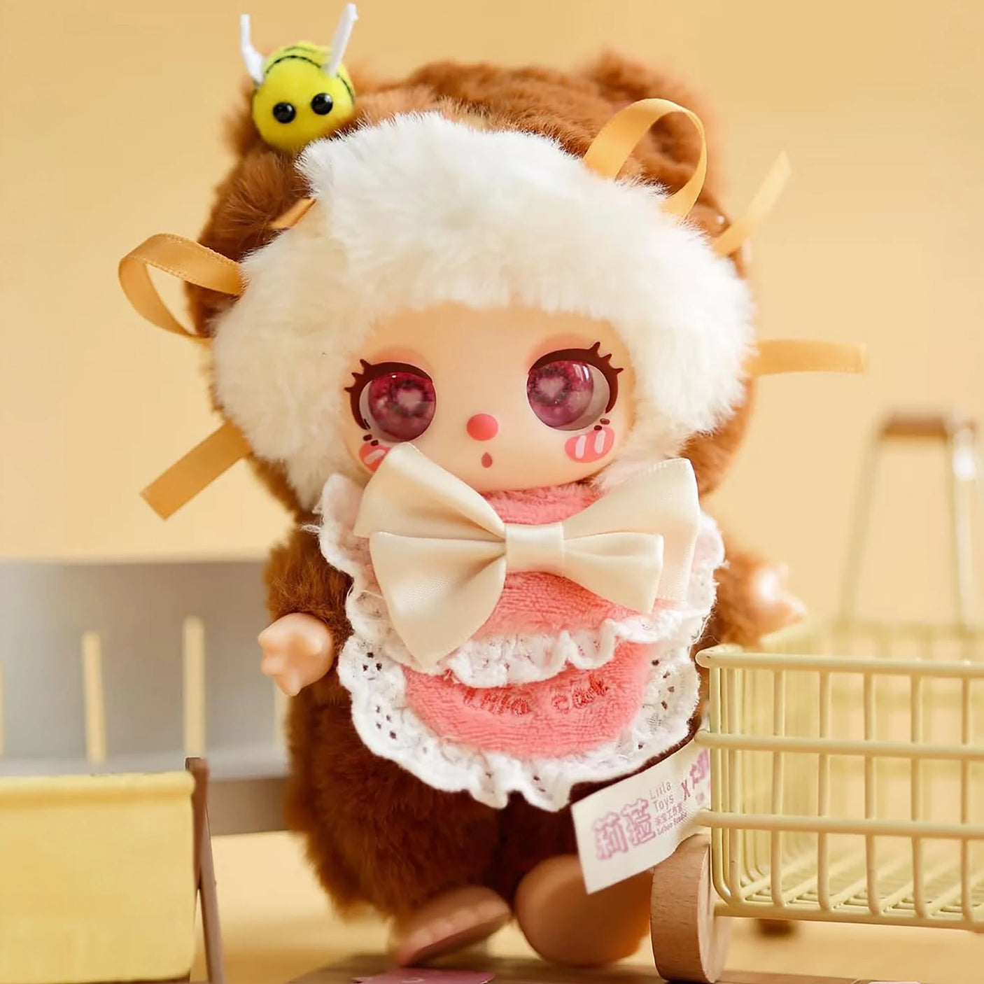Baby Three - Liila's Chef Kitten Blind Box plush doll in soft brown and white onesie with large cream bow and bee accessory