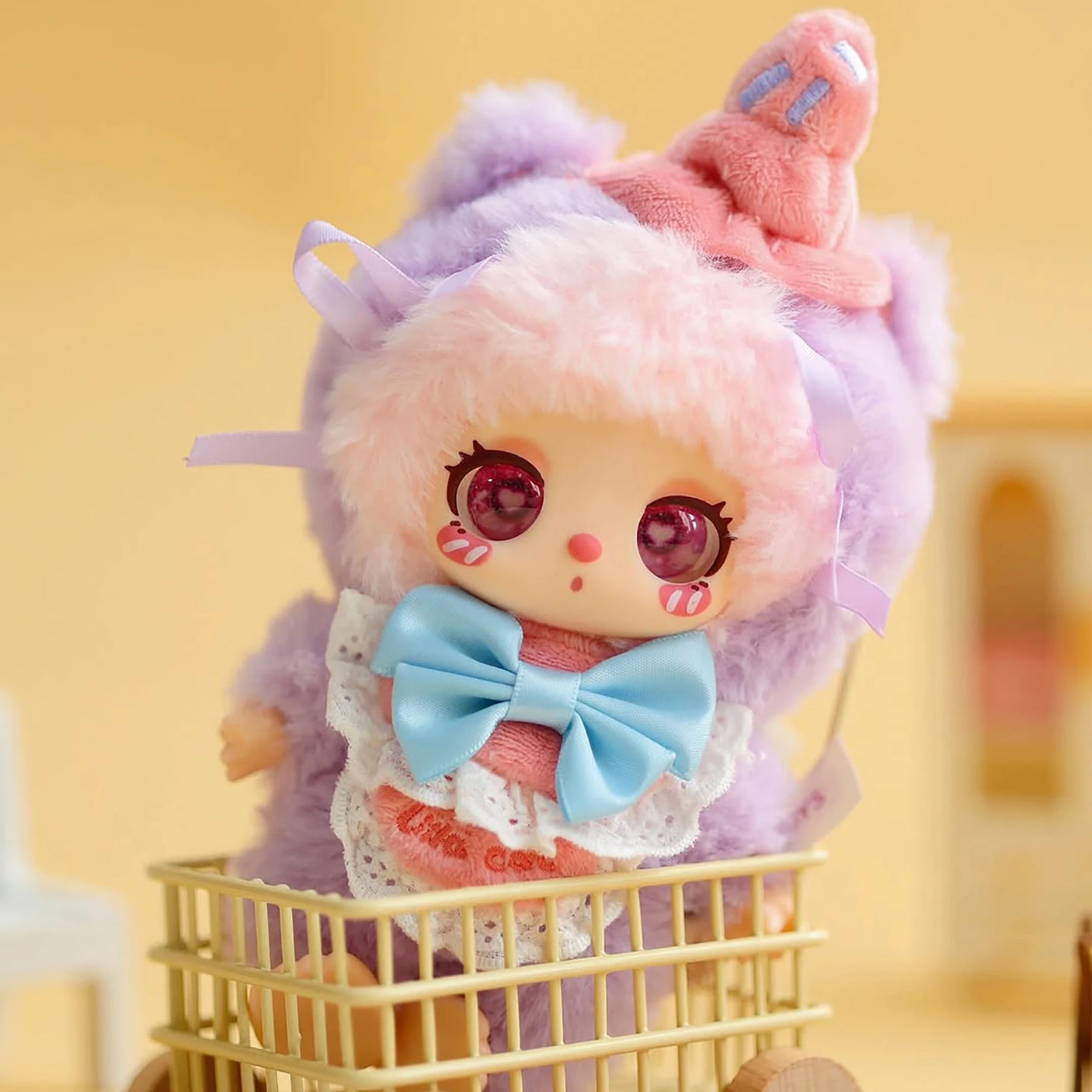 Baby Three - Liila's Chef Kitten Blind Box plush doll in pastel purple and pink onesie with blue bow and cupcake hat accessory.
