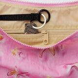 Pink nylon crescent bag with tan zipper and black logo strap key ring