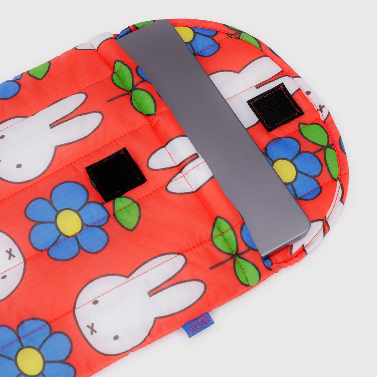 Puffy laptop case with red bunny and flower print, gray interior pocket