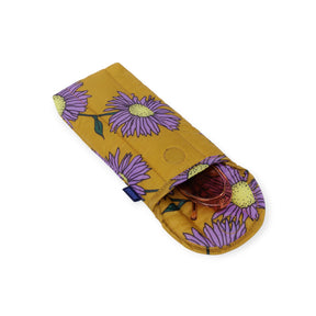 Baggu Puffy Glasses Sleeve in Daisy Chain pattern with purple flowers on mustard yellow, open with glasses inside, gallery position 1