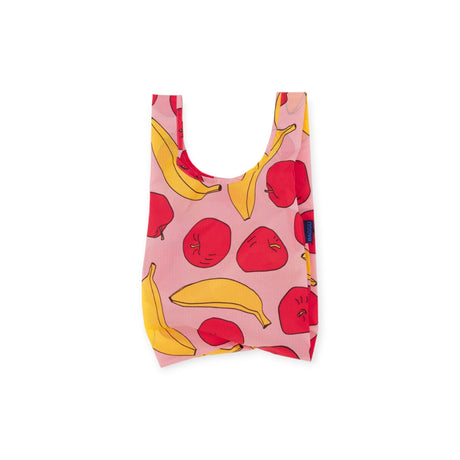 The Baby Baggu Reusable Bag from Baggu features a pink background with a playful pattern of vibrant red apples and yellow bananas, all crafted from recycled nylon.