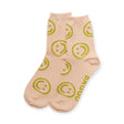 These light pink Baggu Crew Socks, featuring green smiley faces, are made from soft bamboo rayon. They have the brand name near the cuff and add a delightful mood boost with each wear.