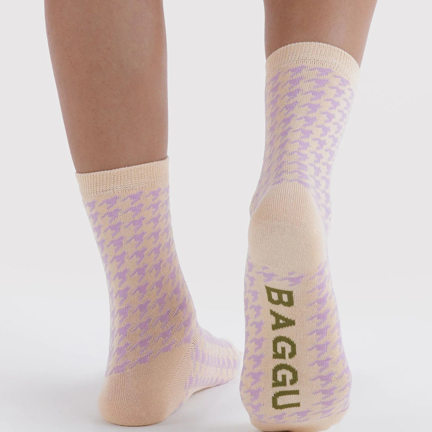 Crew socks with houndstooth and Baggu text at the cuff, tan toe