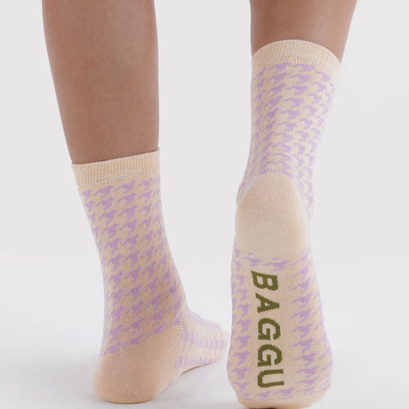 Crew socks with houndstooth and Baggu text at the cuff, tan toe