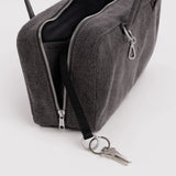 Washed black denim bowler bag open, showing zippers and keyring with keys.