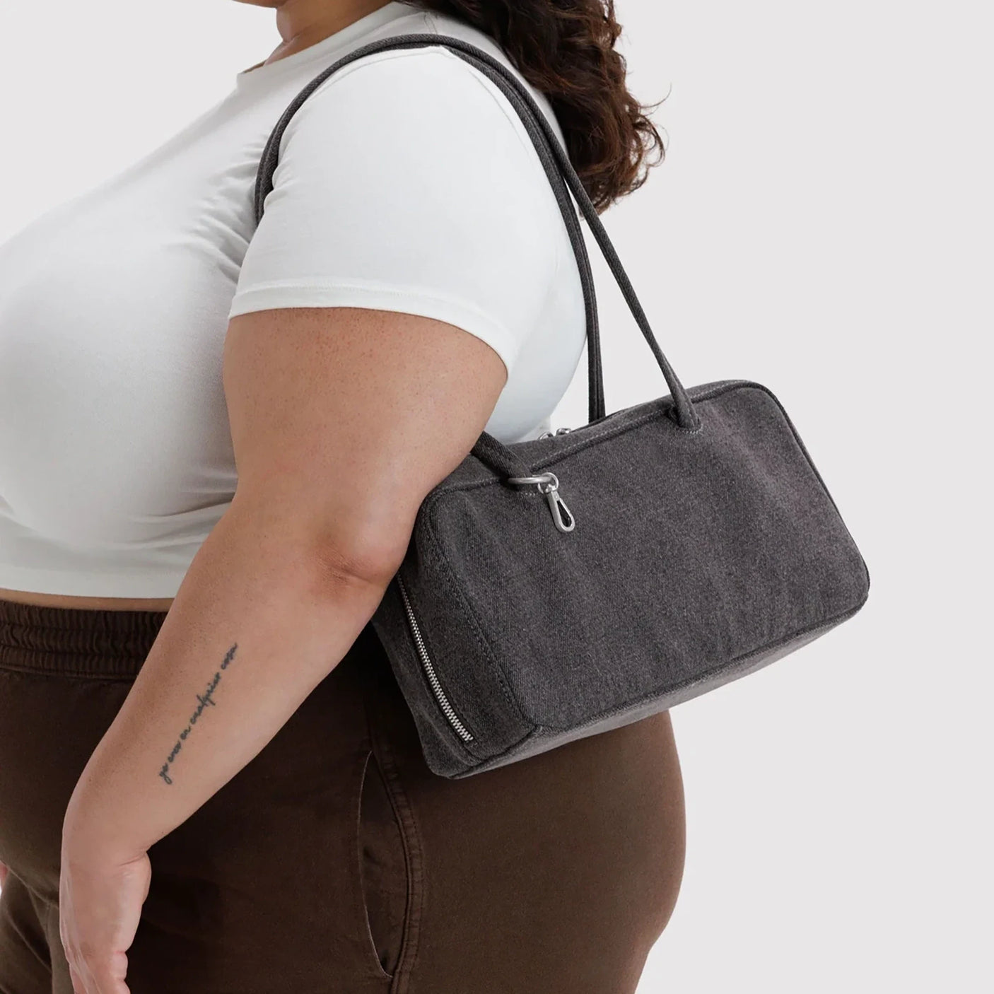 Washed black denim bowler bag with top handles and front side zipper pocket.