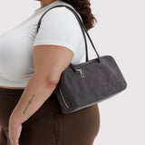 Washed black denim bowler bag with top handles and front side zipper pocket.