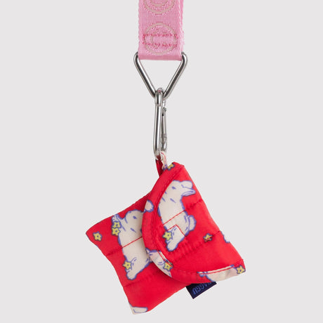 Baggu logo keychain with pink strap, metal ring, and red fabric bow charm