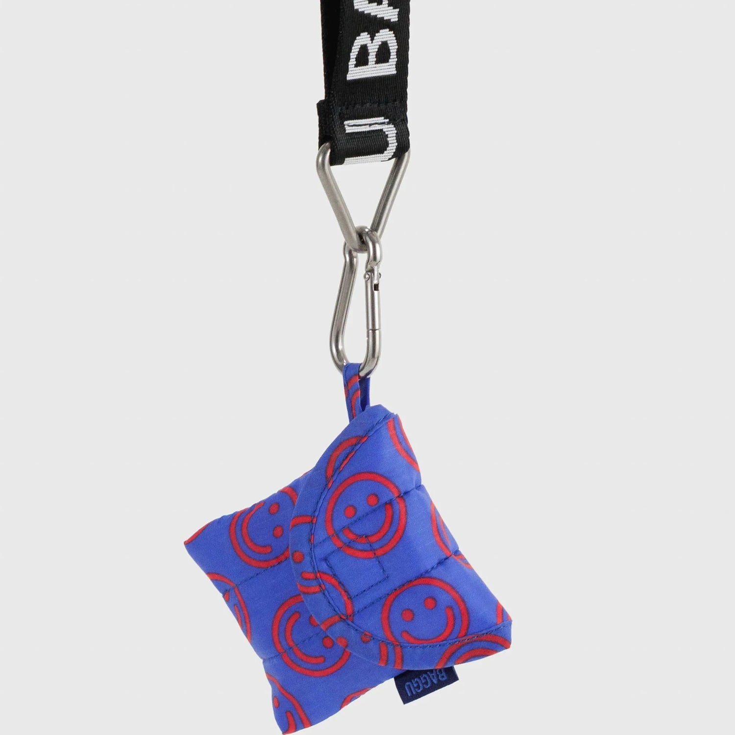 Baggu mini puffy earbuds case in cobalt blue with smiley circles; keychain clip