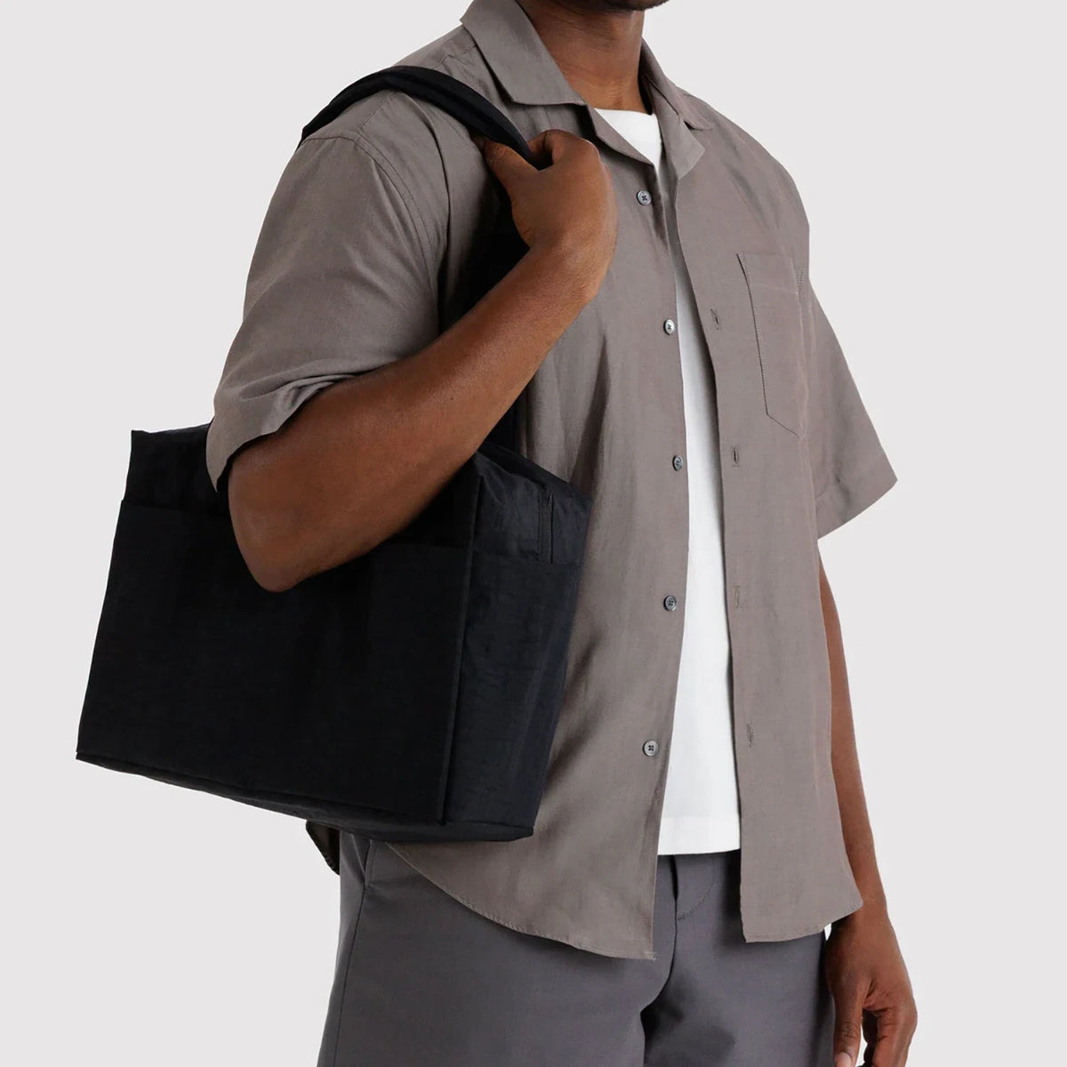 Black Baggu Everyday Cloud bag tote with top handles, shown being carried