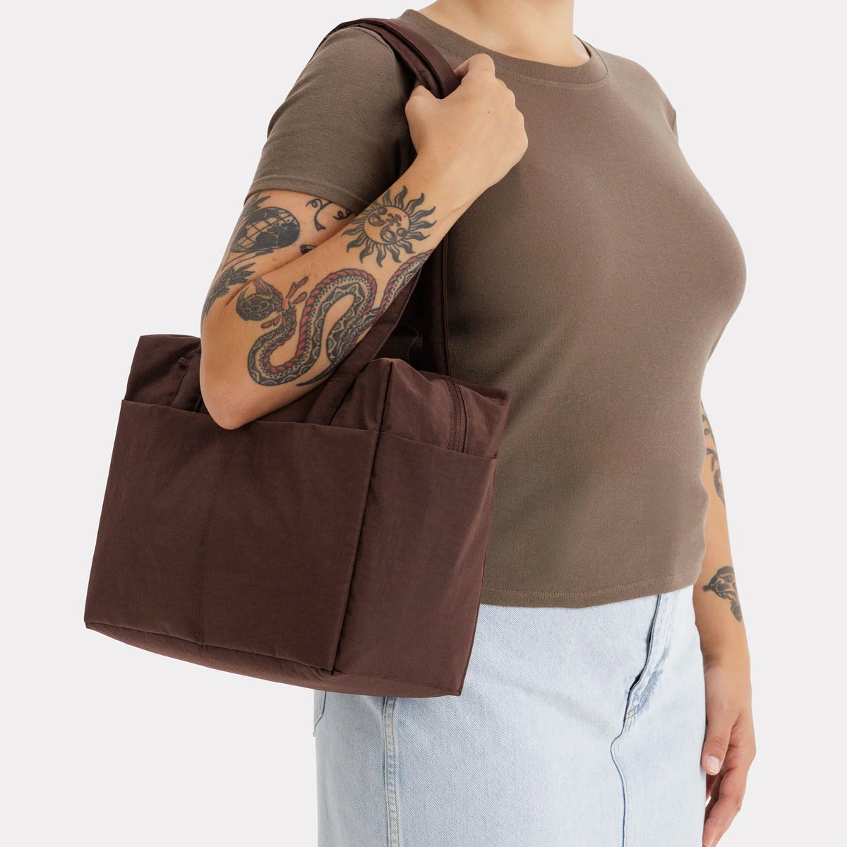 Brown canvas tote bag with flat handles and structured side gussets