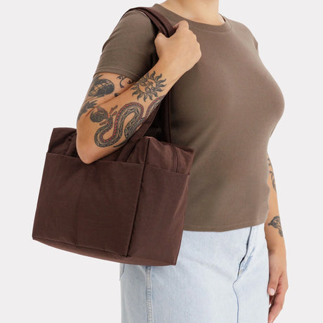 Brown canvas tote bag with flat handles and structured side gussets