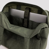 Olive green bag interior with zip pocket and label webbing strap