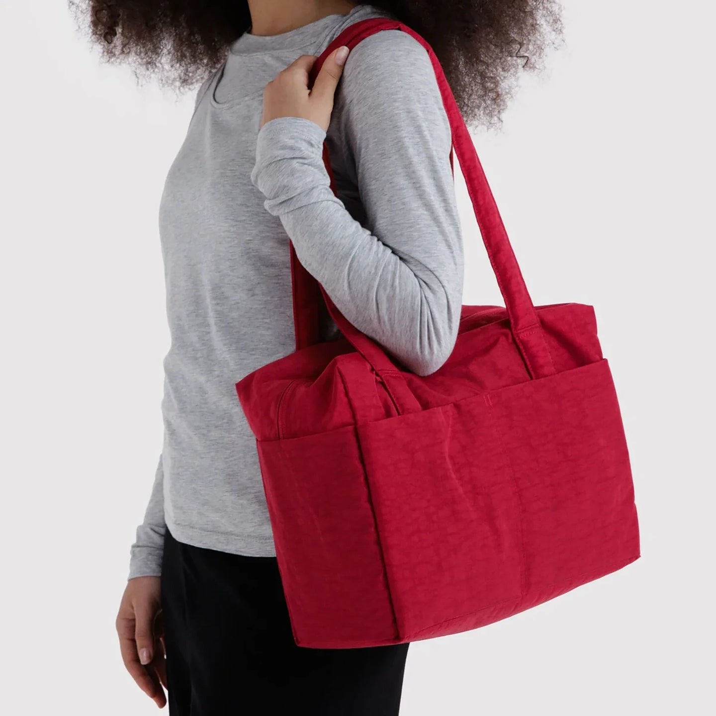 Cherry red tote bag with long handles and structured quilted front