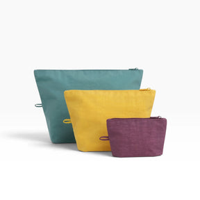 Baggu Go pouch set of 3 with zip tops, teal, mustard yellow and purple.