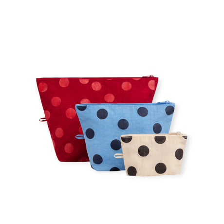 Three polka dot zip pouches: red, blue, and tan with black dots.
