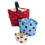 Three polka dot zip pouches, one opened; red, blue, and tan with black dots.