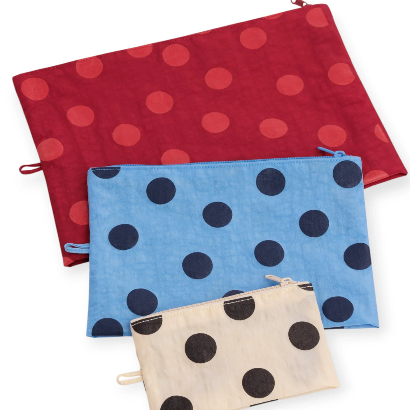 Polka dot pouch set with three flat zip pouches: red, blue, and tan, black dots.