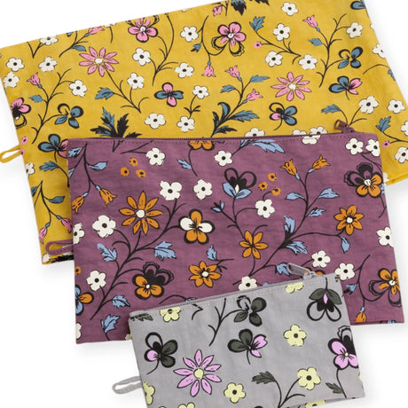 Floral zip pouch set of 3 overlapping: mustard yellow, plum purple, and white