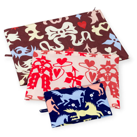 Flat lay of Baggu Go Pouch Set in Western Cut-Out patterns featuring three zippered pouches with bold designs