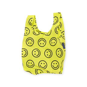 Yellow Baby Baggu reusable shopping bag with black smiley face pattern on white background