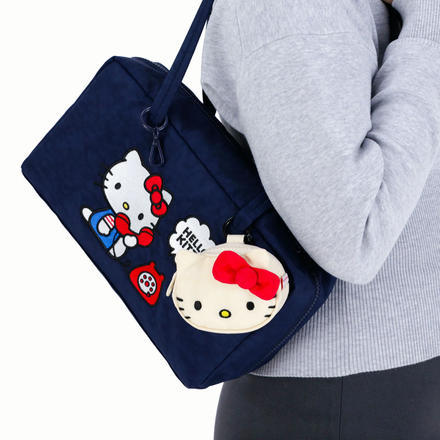 Navy Hello Kitty x Baggu Nylon Bowler Bag with front Hello Kitty graphic and matching plush bag charm, gallery image 1