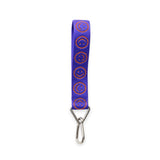 Baggu logo keychain with lapis blue strap and orange smiley circles, metal clip