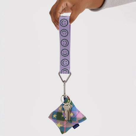 Lilac smiley logo keychain strap with silver hook and multicolor charm, upright