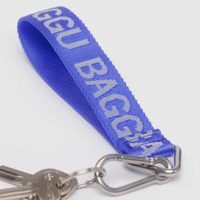 Blue Baggu logo keychain strap with silver keyring and clasp, close-up