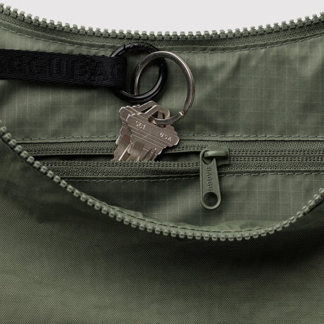Crescent bag interior close-up with zipper, key ring, and Baggu logo pull tab